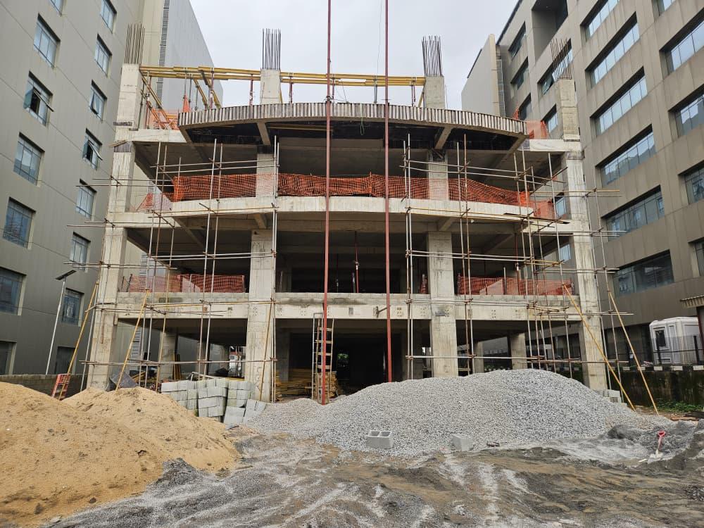 Construction stage of the office development showing concrete frame and scaffolding